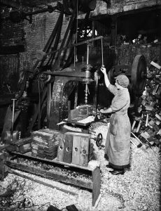 Woman Operating Boring Machine Boring Wooden Reels For Winding Barbed Wire